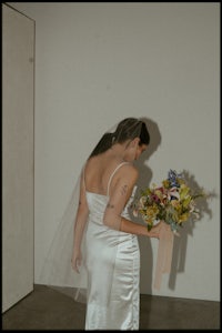 a woman in a white dress holding a bouquet