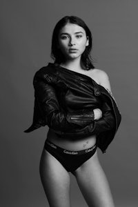 a woman in black underwear posing for a black and white photo